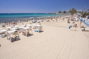 a beach with a lot of people and the ocean at Apartamento Valdes in Alicante