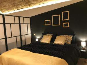 a bedroom with a black bed with two pillows at CasAphrodite in Rome