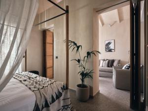 a bedroom with a bed and a potted plant at Casa di Pierro in Lithakia