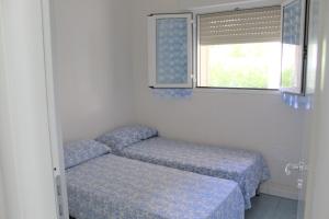 Postel nebo postele na pokoji v ubytování villino sabbia d'oro