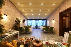 a restaurant with tables and chairs in a room at Elyka Hotel in Istanbul