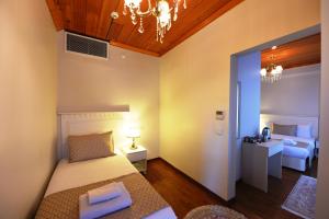 A bed or beds in a room at Elyka Hotel