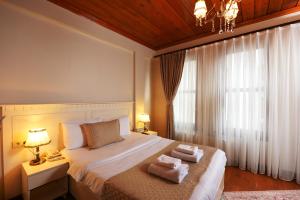 A bed or beds in a room at Elyka Hotel