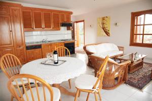 a dining room with a table and chairs and a kitchen at Finca La Punta in Icod de los Vinos