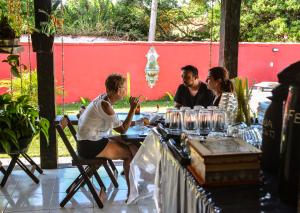 a group of people sitting at a table at Pousada Bela Casa Geribá in Búzios