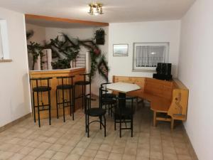 a room with a table and chairs and a bar at Landhaus Breitenberg in Bad Hofgastein +8 photos