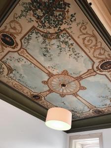 a coffered ceiling with a painting on it at Hotel Jardim in Coimbra