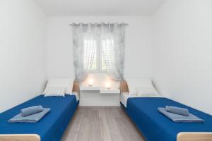 Posteľ alebo postele v izbe v ubytovaní Apartments Peca