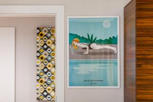 a framed picture of a horse next to a swimming pool at Apartamenty Black&White in Gdynia