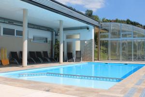 a swimming pool in front of a house at Panoramadorf Saualpe in Eberstein