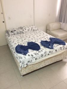a bed with blue sheets on it in a room at Studio in Copa in Rio de Janeiro