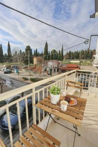 a table with a plate of food on a balcony at Pantheon City Center Studio in Thessaloniki