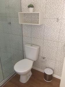 a bathroom with a toilet and a plant on a shelf at HBC 15 in Natal +11 photos