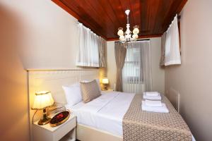 A bed or beds in a room at Elyka Hotel