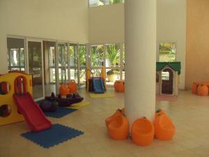 a room with a play area with a playground at Apartamento Riviera Ilha da Madeira in Riviera de São Lourenço