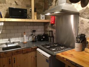 uma cozinha com um fogão e um lavatório em The Barn | Aberlour em Aberlour