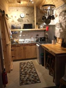 a kitchen with a sink and a stove top oven at The Barn | Aberlour in Aberlour