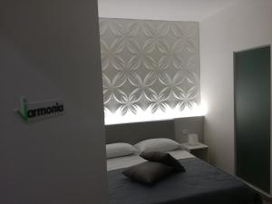 a bedroom with a bed and a window with a flower pattern at Vittoria Wellness in San Giuseppe Vesuviano