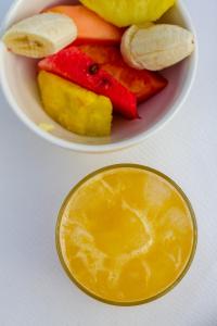 a bowl of fruit with bananas and a drink at Cartagena Legends in Cartagena de Indias