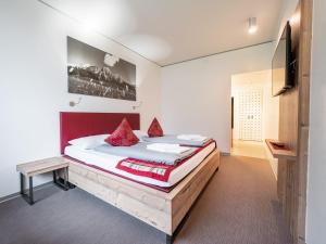 een slaapkamer met een groot bed met een houten frame bij MyTirol in Biberwier