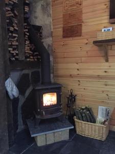 a stove in a room with a wooden wall at The Barn | Aberlour in Aberlour