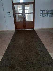 an empty room with a door and a carpet at Apartman Kupres Holiday in Kupres