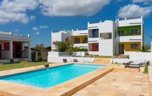Villa con piscina frente a una casa en Pousada lagoa da Barra Taiba, en Taíba