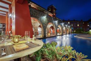 
a dining room with a balcony overlooking a city at Los Sueños Marriott Ocean & Golf Resort in Jacó
