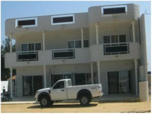 a white truck parked in front of a building at EDEN BEACH SAINT-LOUIS in Saint-Louis