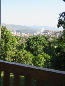 a view of a city from a balcony with trees at Lagoa Seca Hotel Rural in São Lourenço