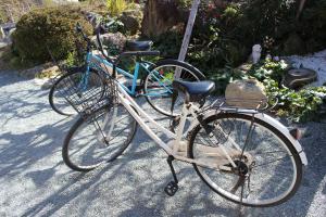 a bike with a basket parked on the street at Guest House TERASU in Fukuoka