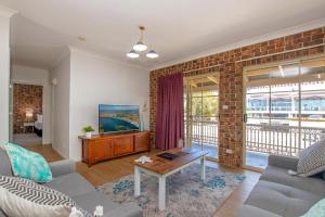 a living room with a brick wall at Richmond Motor Inn in Ballina