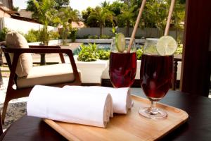 a table with two glasses of red wine and paper towels at Sunrise Garden House - Luang Prabang in Luang Prabang