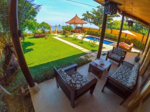 an aerial view of a patio with chairs and a yard at Ocean Beachfront Villa Dini in Banjar