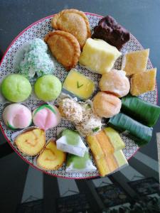 a plate of different types of food on a table at INNI Homestay in Malang +51 photos