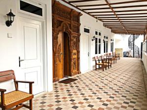 a corridor with a row of chairs in a building at The LaWang Yogya Guesthouse in Yogyakarta