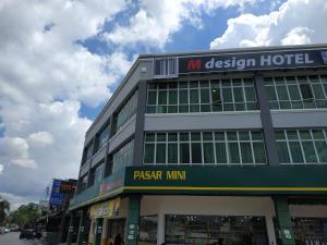 a building with a sign for a hotel at M Design Hotel @ Bangi 7 in Bangi