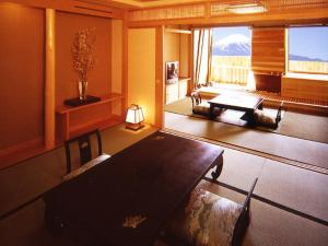 a hotel room with a bed, desk, and chair at Lakeland Hotel Mizunosato in Fujikawaguchiko