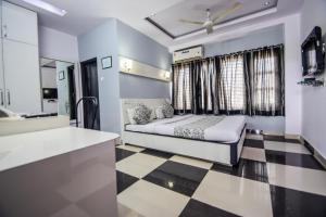 a bedroom with a bed and a checkered floor at Hotel The Space in Udaipur