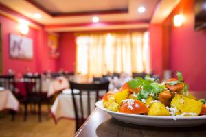 a plate of food on a table in a restaurant at Golden Dolma in Darjeeling