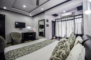 a hotel room with a bed and a television at Hotel The Space in Udaipur