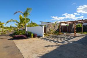 a house on a street with palm trees at Luxurious Villa - Beach 1039m, Golf & Malls 4mn in Grand Baie
