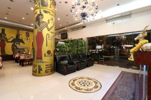 a lobby with a large column in a store at OYO 102 Diamond Residence Silom in Bangkok