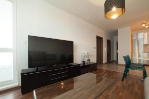 a living room with a large flat screen tv at After Eight Apartment in Bratislava