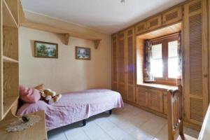 a bedroom with a bed with a teddy bear on it at Bungalow El Mar in Teguise +8 photos