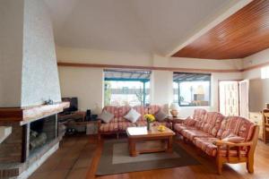 a living room with a couch and a fireplace at Bungalow El Mar in Teguise