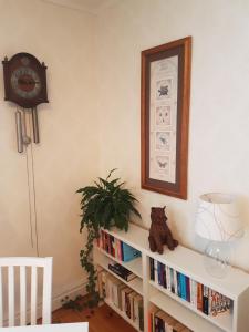a teddy bear sitting on top of a book shelf at Hedesunda Bed & Breakfast in Hedesunda