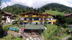 a house in the mountains with a yard at Landhaus Kitzblick in Piesendorf