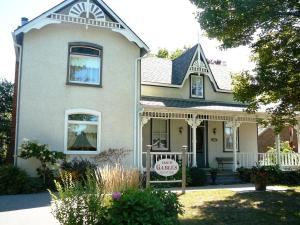 a house with a for sale sign in front of it at Gables Bed & Breakfast in Stayner