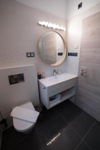 a bathroom with a white sink and a mirror at Villa Mango 2 in Balatongyörök